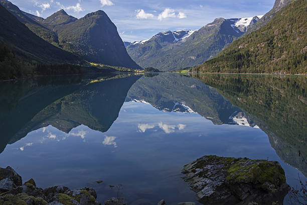 istock Peaks reflecting in mountain lake 636209622