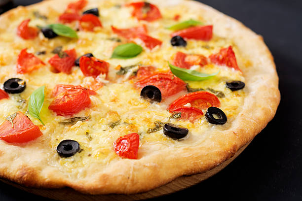 istock Pizza with tomato, mozzarella, basil and olives. 636210170