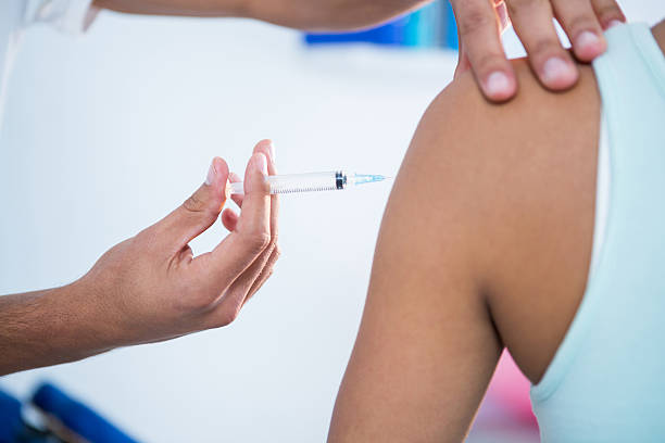 istock Physiotherapist injecting female patient 636213930