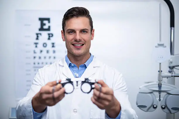 Photo of Smiling optometrist holding messbrille