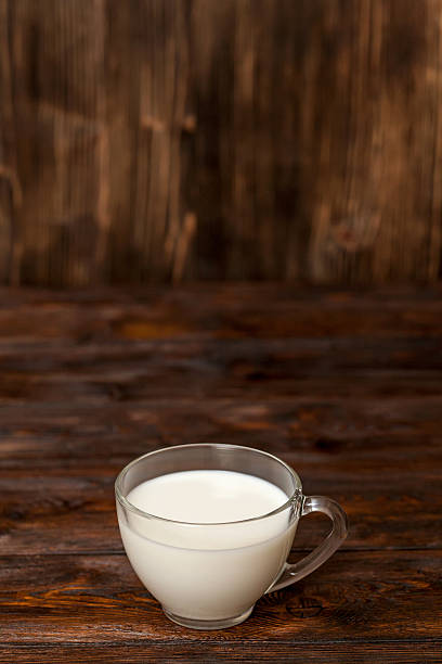 istock Cup of milk on rustic wooden table 636214126