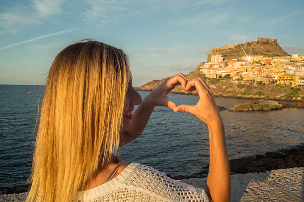 istock Young woman in Italy makes a heart shape finger frame 636214506