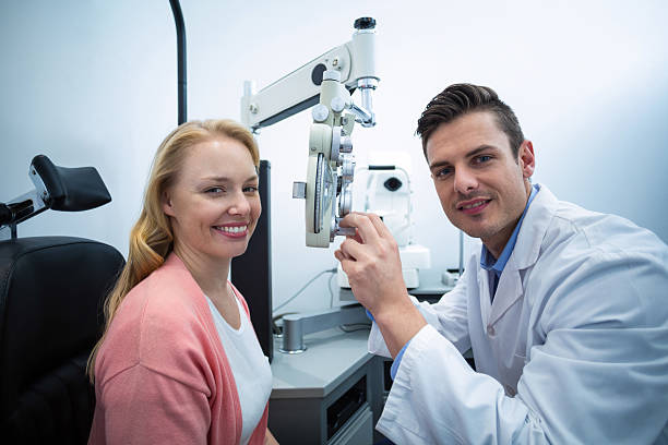 istock Optometrist examining female patient on phoropter 636214866