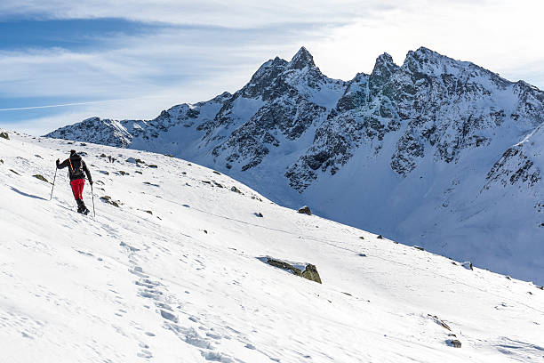 istock Hiker walks on snowy mountain 636216560