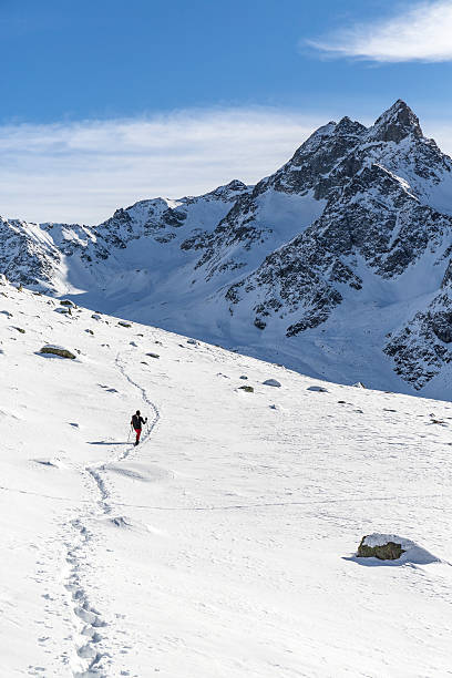 istock Hiker walks on snowy mountain 636216632