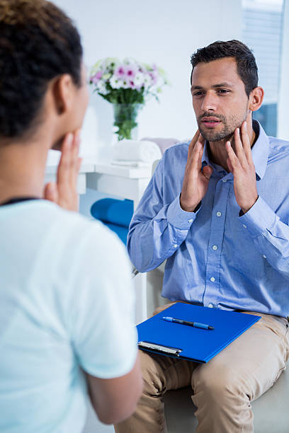 istock Physiotherapist talking with patient with neck pain 636218618