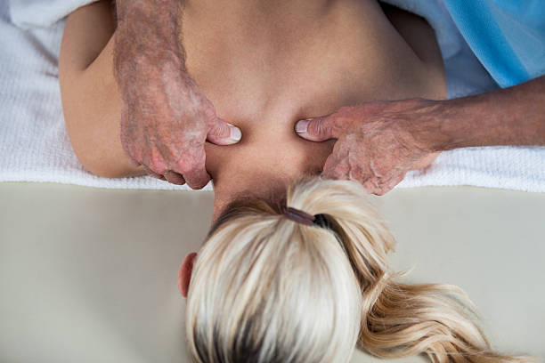 istock Woman receiving shoulder massage from physiotherapist 636218828