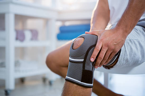 istock Mid section of man with knee injury 636219094
