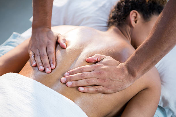 istock Woman receiving back massage from physiotherapist 636219234