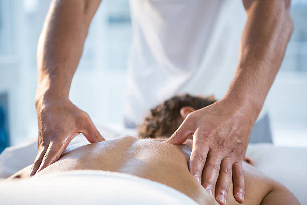 istock Woman receiving back massage from physiotherapist 636219304