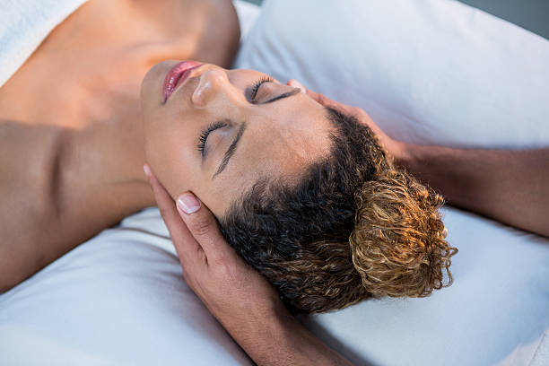 istock Woman receiving head massage from physiotherapist 636220578