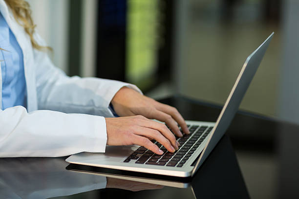 istock Optometrist using laptop in ophthalmology clinic 636221142