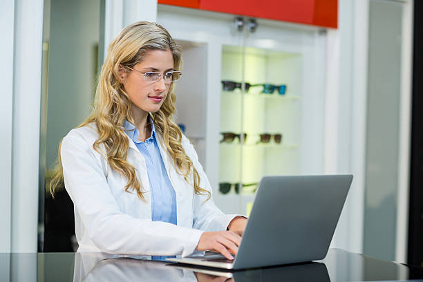istock Optometrist using laptop in ophthalmology clinic 636221150