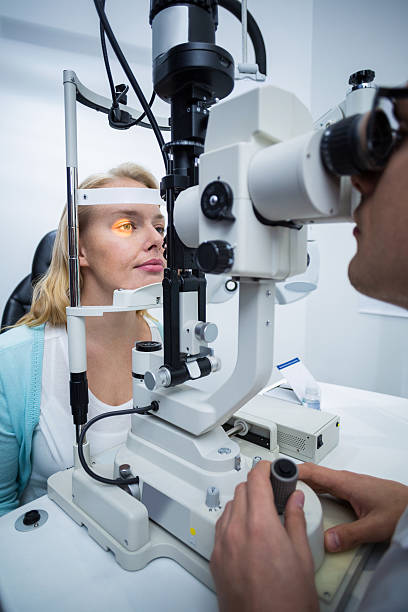 istock Optometrist examining female patient on slit lamp 636221826