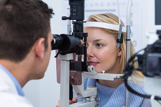 istock Optometrist examining female patient on slit lamp 636222344