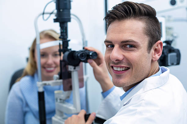 istock Optometrist examining female patient on slit lamp 636222384