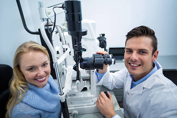 istock Optometrist examining female patient on slit lamp 636222400