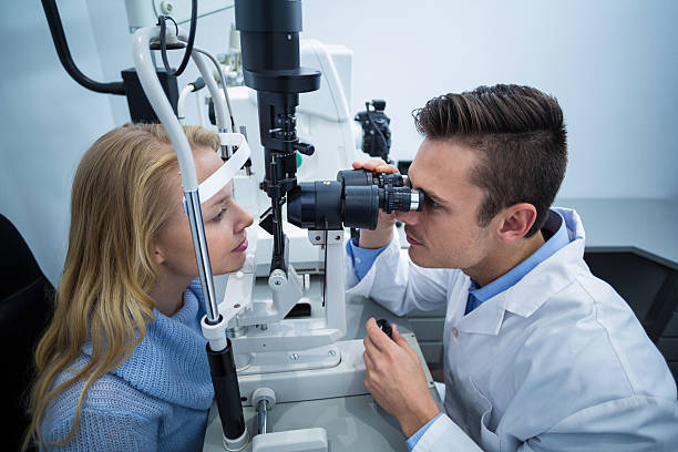 istock Optometrist examining female patient on slit lamp 636222416