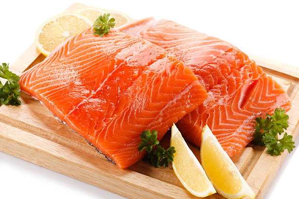istock Fresh raw salmon fillet on cutting board on white background 636223072