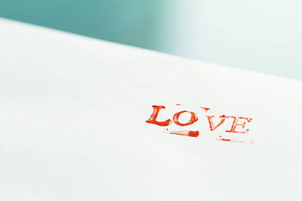 Envelope with letters LOVE  on a table. Love concept