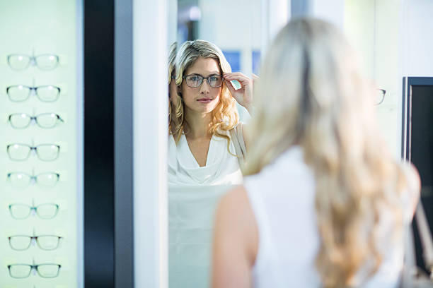istock Beautiful female customer trying spectacles 636223224