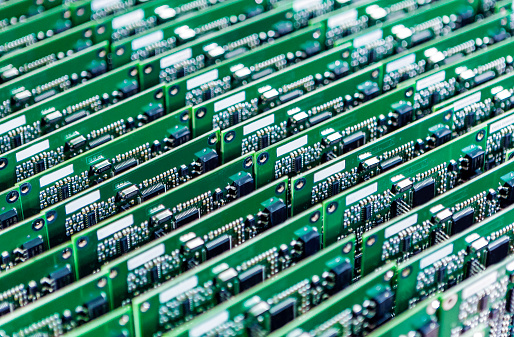 Lots of Printed Circuit Boards With Mounted and Soldered Componentry Arranged in Rows Together. Horizontal Image