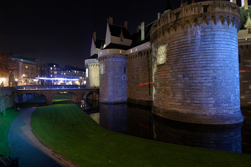 Nantes, France - December 6, 2016: A Night Image of The Chateau des Ducs De Bretagne which is in the centre of Nantes. Built in the late 15th century by François II, the last Duke of Brittany, and by his daughter, Anne of Brittany, Duchess and twice queen of France, the Chateau des Ducs de Bretagne houses a residential palace with stone limestone façades and refined Renaissance loggias.