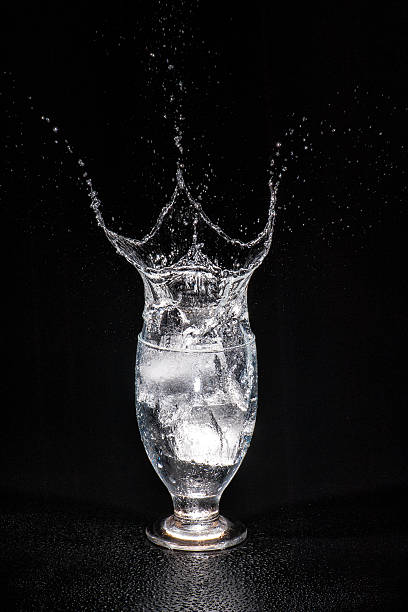 splashing water with ice cube - brand named water imagens e fotografias de stock