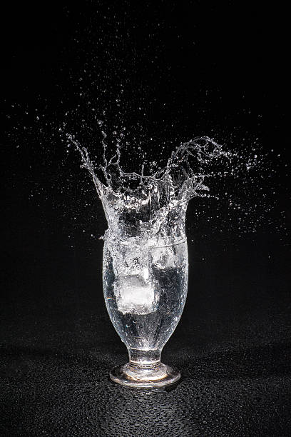 splashing water with ice cube - brand named water imagens e fotografias de stock