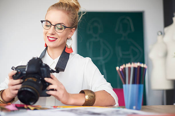 istock Female photographer looking at her images 636225694
