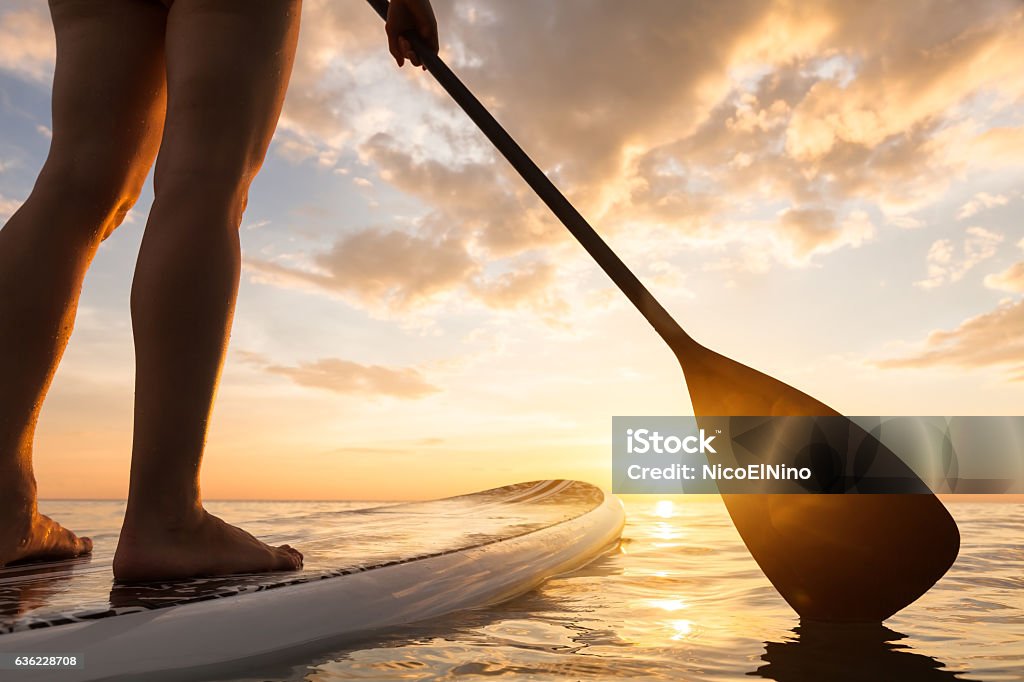 Stand Up Paddle Boarding auf ruhigem Meer, Beine Nahaufnahme, Sonnenuntergang - Lizenzfrei Paddle-Surfing Stock-Foto