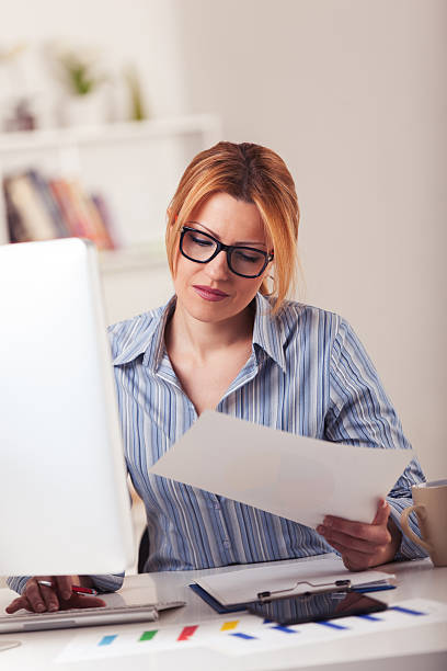 istock Businesswoman working from home office analyzing market research statistics 636230620