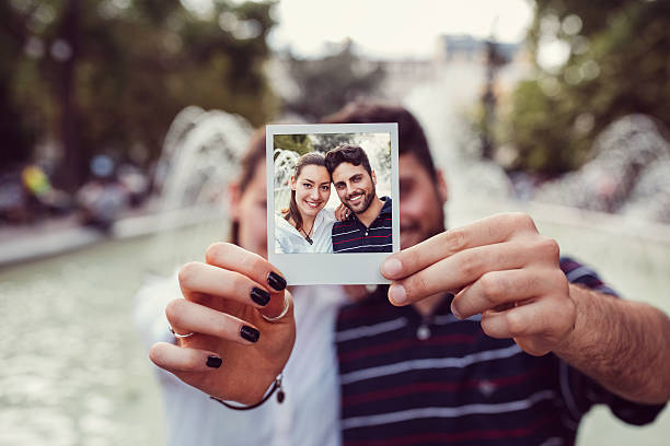 istock Happy couple showing instant selfie 636231030