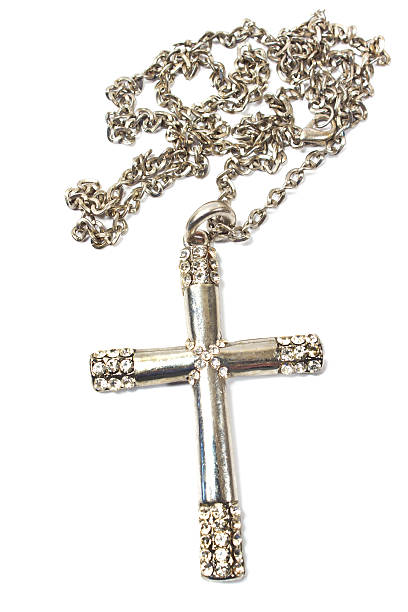 istock Silver christian cross necklace isolated on white 636231652