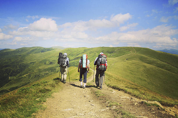 Man tourist walking the mountains with a backpack.