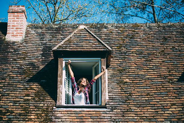 istock Smiling woman on the rooftop window 636232034