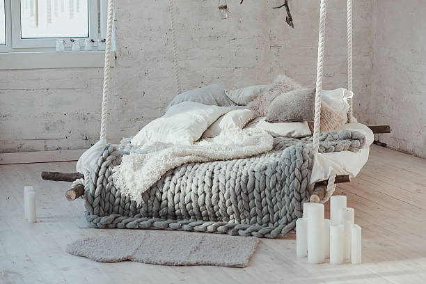 istock The bed suspended from the ceiling. Grey big cozy blanket 636232414