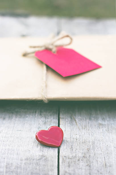istock Gift in kraft paper with red card and heart 636232906