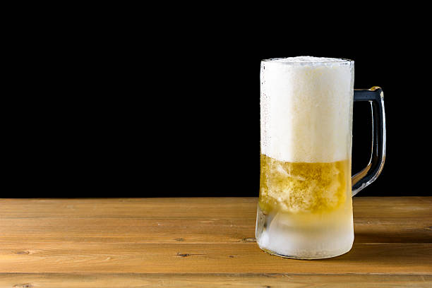 istock glass beer on a wooden 636233098