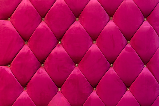 background of shocking pink velvet sofa with crystal botton