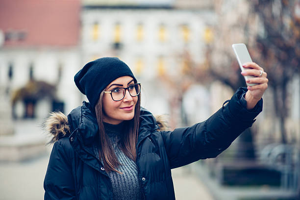 istock woman using phone in city 636234132