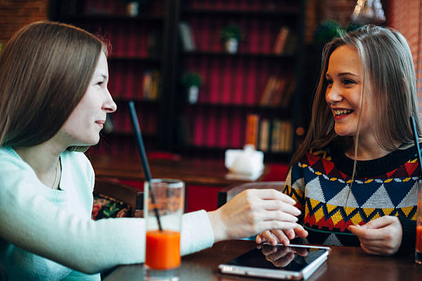 istock Girl friends communicate in a cafe 636234216