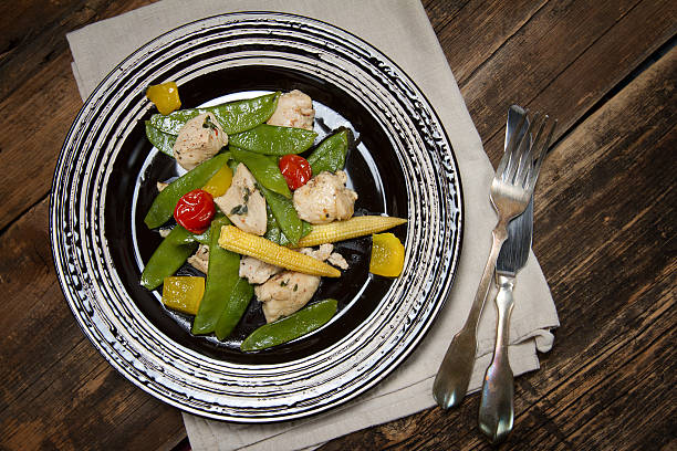 istock Braised chicken breast with young peas, corn and cherry tomatoes 636238180
