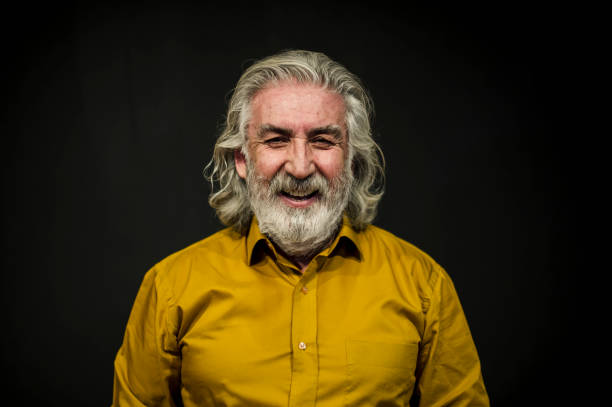 istock Senior Smiling Man Portrait Front of A Black Wall 636238614