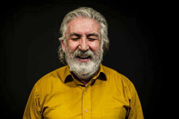 istock Senior Smiling Man Portrait Front of A Black Wall 636238670