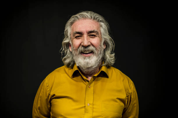 istock Senior Smiling Man Portrait Front of A Black Wall 636238722