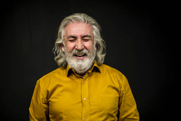 istock Senior Smiling Man Portrait Front of A Black Wall 636239126