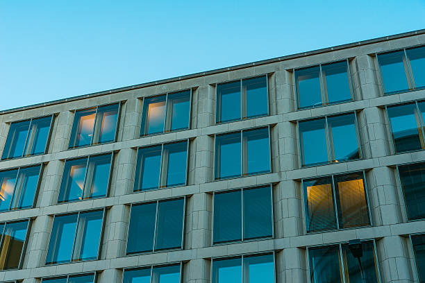 istock office building with big blue and orange windows 636239654