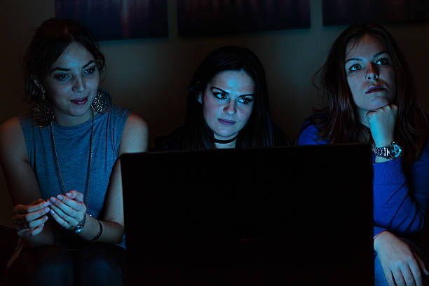 istock Three girlfriends, watchng something boring on laptop 636239664