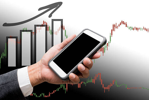 istock hand hold smart phone with business graph 636240796